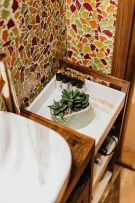 a bathroom with a sink and a potted plant on a counter at Apartament Shahrazad in Kraków