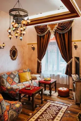 a living room with a couch and a table at Apartament Shahrazad in Kraków