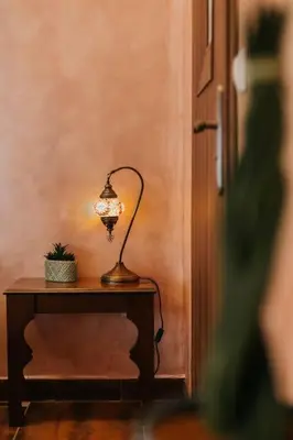 a lamp sitting on a table in a room at Apartament Shahrazad in Kraków