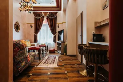 a living room with a couch and a window at Apartament Shahrazad in Kraków