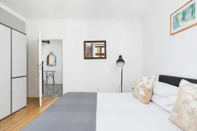 a white bedroom with a white bed and a white refrigerator at Two Bedroom Apartment- Brzozowa - Kazimierz in Kraków