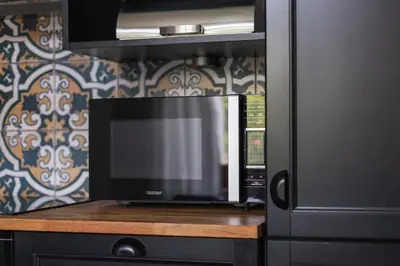 a microwave oven sitting on top of a counter at Two Bedroom Apartment- Brzozowa - Kazimierz in Kraków