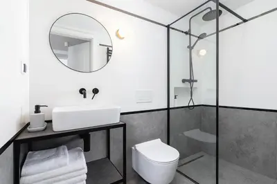 a bathroom with a sink and a toilet and a mirror at Old Town - Modern Apartment - 7 Gertrudy street in Kraków