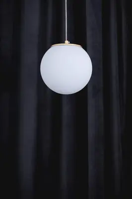 a white light hanging from a black wall at Old Town - Modern Apartment - 7 Gertrudy street in Kraków