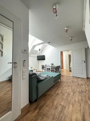 a living room with a bed and a dining room at Moonlight Apartment Cracow in Kraków