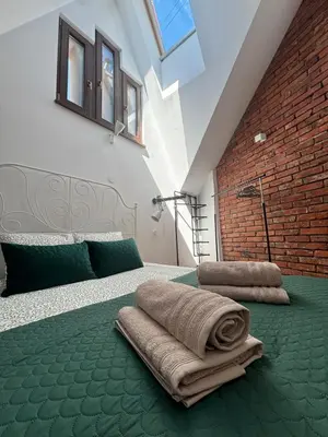 a bedroom with a bed with towels on it at Moonlight Apartment Cracow in Kraków