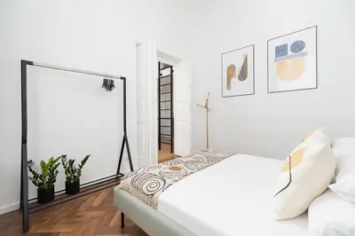 a white bedroom with a bed and a window at Wawel Castle - Modern Apartment - 7 Gertrudy in Kraków