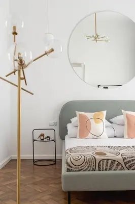 a bedroom with a bed and a floor lamp at Wawel Castle - Modern Apartment - 7 Gertrudy in Kraków