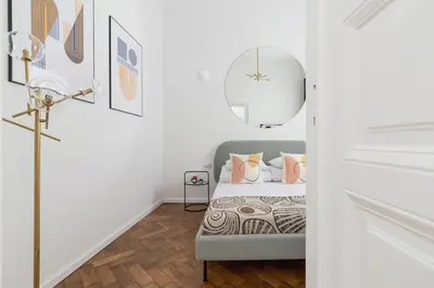 a white bedroom with a bed and a mirror at Wawel Castle - Modern Apartment - 7 Gertrudy in Kraków