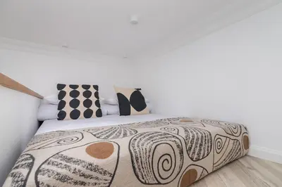 a bed with a black and white comforter and pillows at Wawel Castle - Modern Apartment - 7 Gertrudy in Kraków