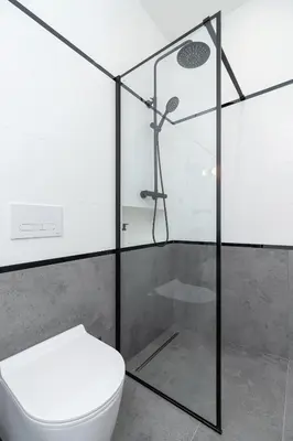 a bathroom with a toilet and a glass shower at Wawel Castle - Modern Apartment - 7 Gertrudy in Kraków