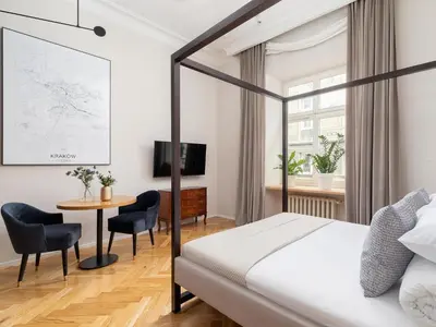 a bedroom with a bed and a table and chairs at Main Square - Szpitalna 9 Street in Kraków