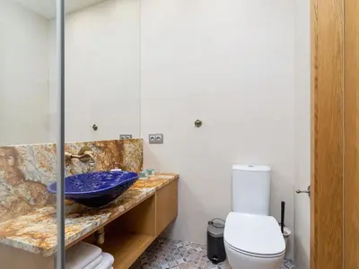 a bathroom with a blue sink and a toilet at Main Square - Szpitalna 9 Street in Kraków