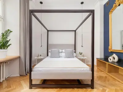 a bedroom with a canopy bed with white sheets at Main Square - Szpitalna 9 Street in Kraków