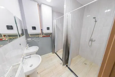 a bathroom with a shower and a toilet and a sink at Hostel Graffiti in Kraków