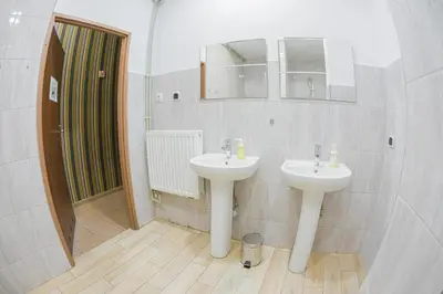 a bathroom with two sinks and a shower at Hostel Graffiti in Kraków