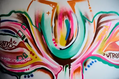 a painting of the word paint on a wall at Hostel Graffiti in Kraków
