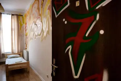 a room with a door with a painting on the wall at Hostel Graffiti in Kraków