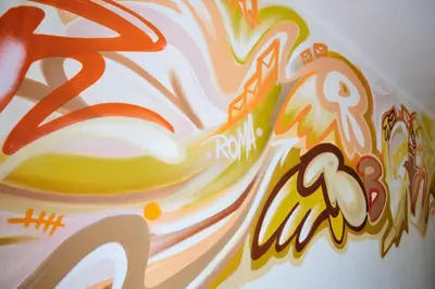 a close up of a painting on a wall at Hostel Graffiti in Kraków