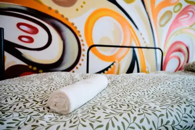 a roll of toilet paper sitting on top of a bed at Hostel Graffiti in Kraków