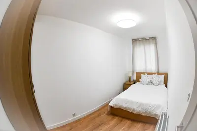 a bedroom with a bed and a large mirror at Elegant Two-Room Apartment, Sleeps 4, Near Turon Arena, Balcony ,Air condition in Kraków