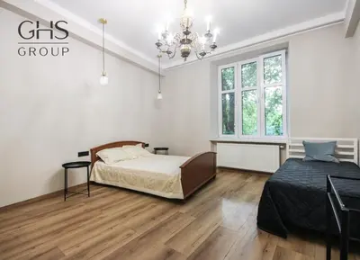 a bedroom with a bed and a chandelier at Royal university apartment, Wawel castle in Kraków