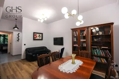 a living room with a dining room table and a couch at Royal university apartment, Wawel castle in Kraków