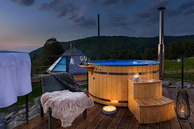 a hot tub on the deck of a house at Osada Poli Zawoja - Panoramiczny Domek z Prywatną Balią i Hydromasażem in Skawica
