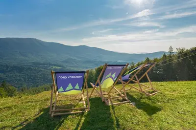 two lawn chairs sitting on top of a hill at Osada Poli Zawoja - Panoramiczny Domek z Prywatną Balią i Hydromasażem in Skawica