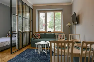 a living room with a couch and a table at Krowoderska Apartament in Kraków