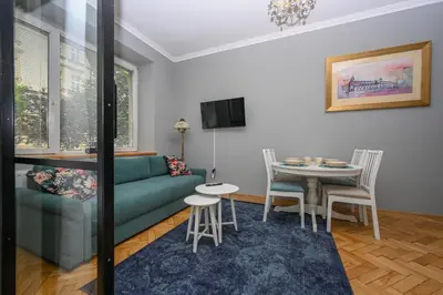 a living room with a couch and a table at Krowoderska Apartament in Kraków