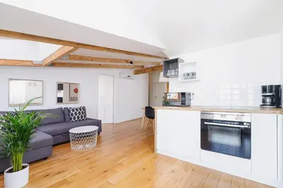 a living room with a couch and a kitchen at 2 bedroom Apartment with terrace- Piłsudskiego 11 in Kraków