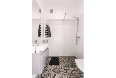 a bathroom with a toilet and a sink and a tub at 1 - bedroom Apartment - 11 Pilsudskiego Street in Kraków