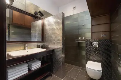 a bathroom with a sink and a toilet and a mirror at Main square - Old Town - Floriańska 47 Street in Kraków