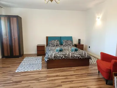 a bedroom with a bed and a red couch at Dom pod Krakowem - zacisze wsi 20 minut samochodem od centrum Krakowa in Pekowice