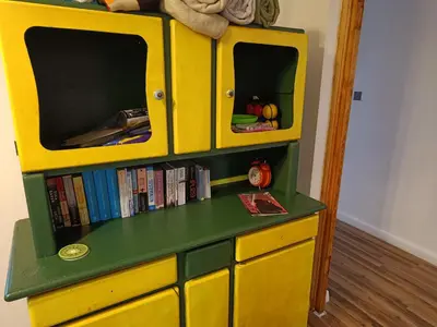a yellow dresser with a tv on top of it at Dom pod Krakowem - zacisze wsi 20 minut samochodem od centrum Krakowa in Pekowice