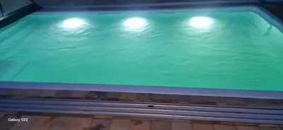 a swimming pool with three lights on top of it at Energylandia Apartamenty u Agi D in Zator