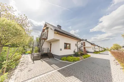 a house with a staircase on the side of it at Energylandia Apartamenty u Agi D in Zator