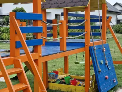 a playground with a ladder and a swing at Energylandia Apartamenty u Agi D in Zator
