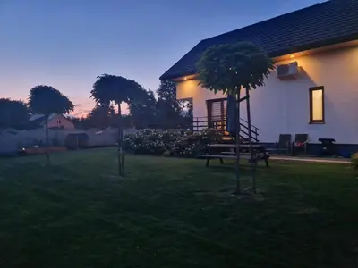 a house with a picnic bench in the yard at Energylandia Apartamenty u Agi D in Zator