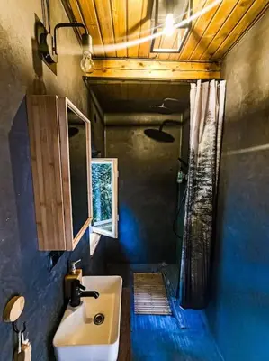 a bathroom with a sink and a shower at Grapa - Magiczna Leśna Chata in Skawica
