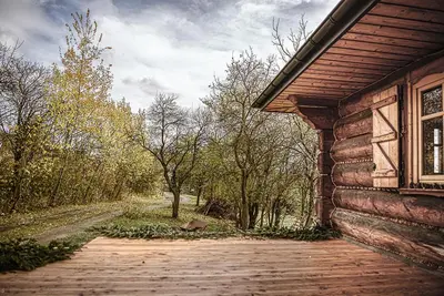 an outside view of a log cabin with a window at Pod lasem i niebem in Lanckorona