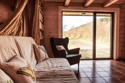 a living room with a couch and a window at Pod lasem i niebem in Lanckorona