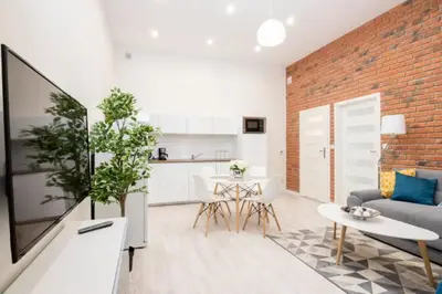 a living room with a couch and a brick wall at One Bedroom Apartment - Dluga 30 street in Kraków