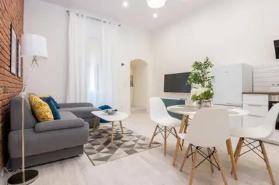 a living room with a couch and a table and chairs at One Bedroom Apartment - Dluga 30 street in Kraków