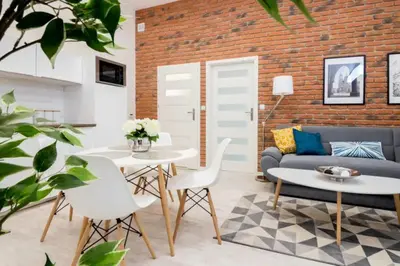 a living room with a couch and a table and chairs at One Bedroom Apartment - Dluga 30 street in Kraków