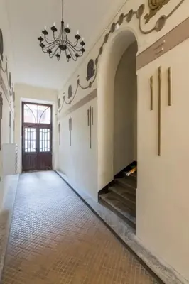 an empty hallway with a chandelier on the ceiling at One Bedroom Apartment - Dluga 30 street in Kraków