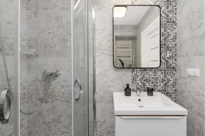 a bathroom with a sink and a shower with a mirror at Air-conditioned apartment in the city center, Old Town in Kraków