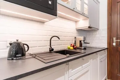 a kitchen with a sink and a mixer on a counter at Vintage Charm in Old Town Krakow Józefa Sarego apt A in Kraków
