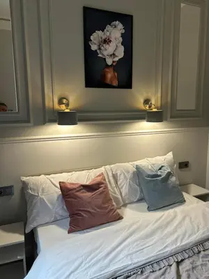a bed with two pillows on it with two lights on top at Vintage Charm in Old Town Krakow Józefa Sarego apt A in Kraków